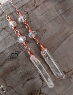 Handmade Copper Mystic Quartz and Crystal Quartz Point Bead Boho Dangle Earrings Comes with Handmade Sterling Silver Ear wires Gift Box or Gift Bag Available for $1.00  $4.75 Shipping to all 50 U.S. States With Tracking. -Please Read before Ordering- The kinds of metals (Sterling Silver, Copper, Brass) used in the jewelry I make are left natural (unsealed) and will develop a natural patina overtime. Metal oxidizes over time when it comes in contact with oxygen in the environment and skin. For many people the acids in your skin combine with the metal and make copper or silver salts which are greenish or gray. They are harmless and just wash off. Bohemian Wire Dangle Jewelry, Spiritual Beaded Dangle Earrings, Spiritual Dangle Beaded Earrings, Copper Dangle Crystal Earrings With Ear Wire, Spiritual Dangle Beaded Earrings With Ear Wire, Spiritual Dangle Crystal Earrings With Ear Wire, Beaded Copper Wire Dangle Jewelry, Beading Board, Quarts Crystal