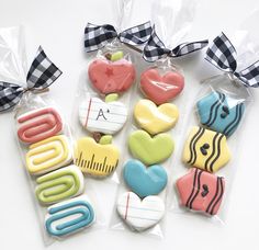 several decorated cookies in plastic bags on a table