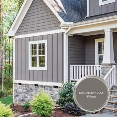 a gray house with white trim and windows