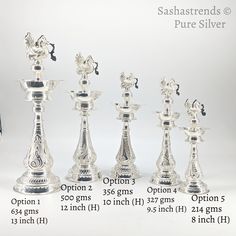 a set of seven silver candlesticks sitting next to each other