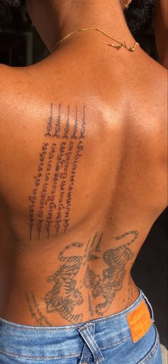 the back of a woman with tattoos on her body