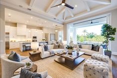 a living room filled with furniture and a ceiling fan