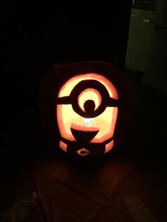 a pumpkin carved to look like pokemon pikachu is lit up in the dark