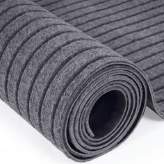 a rolled up gray yoga mat on a white background with clippings for text