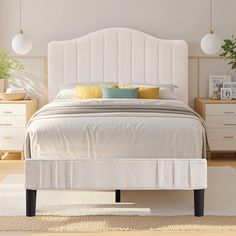 a white bed sitting in a bedroom on top of a wooden floor