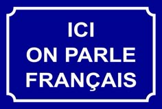 a blue street sign with the words ici on parallel francais written in white