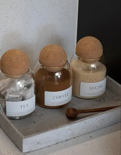 three jars filled with spices sitting on top of a counter