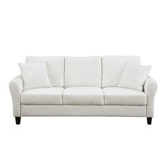 a white couch with four pillows on it