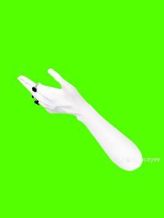 a white hand with black dots on it's fingers is in the air against a green background