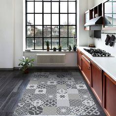 a kitchen with wooden cabinets and an area rug that looks like it has been painted