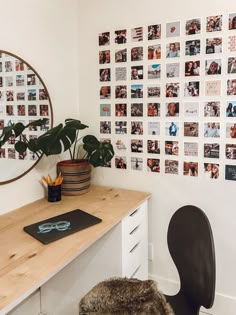 a desk with a chair, mirror and pictures on the wall in a home office