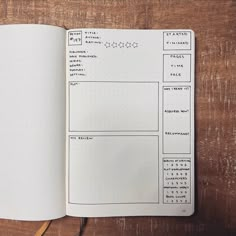 an open notebook with notes and numbers on the pages, sitting on a wooden table