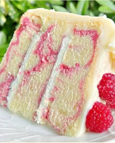 a close up of a slice of cake on a plate with raspberry topping