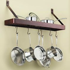 pots and pans are hanging on the wall