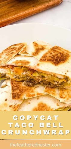 a white plate topped with a quesadilla cut in half and stacked on top of each other