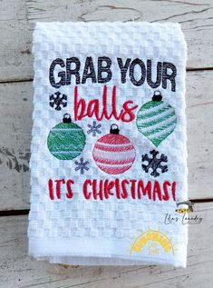 a white towel with christmas ornaments on it that says grab your balls, it's christmas