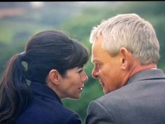 an older man and young woman looking at each other