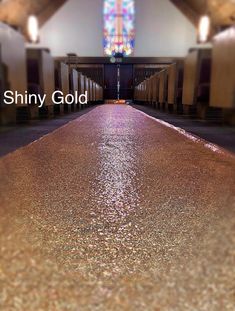 the inside of a church with stained glass windows and pews on either side of the aisle