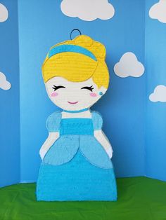 a paper doll made to look like a princess with blue dress and yellow headband