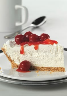 a piece of cheesecake with cherries on top