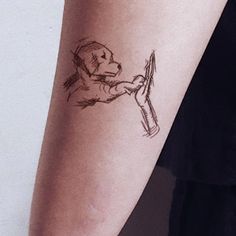 a person with a tattoo on their arm holding a wrench in one hand and a hammer in the other