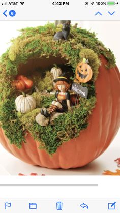 an image of a pumpkin decorated with moss and witches on it's side for halloween