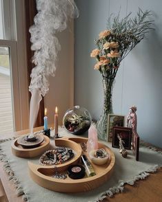 a wooden tray with candles and other items on it