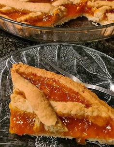 a slice of pie sitting on top of a glass plate next to another pie dish