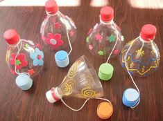 several empty plastic bottles sitting on top of a wooden table next to other small objects