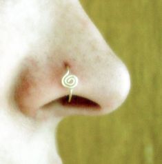 a nose piercing with a spiral design on it