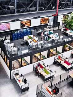 an overhead view of office cubicles with people working on desks in the center