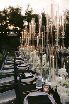 a long table with candles and flowers on it