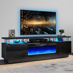 an entertainment center with a large television and sound system on it's side wall