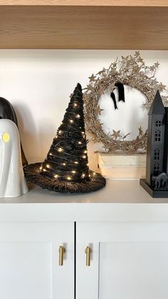 a white shelf topped with black and white christmas decorations