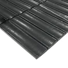 black plastic sheets are stacked on top of each other