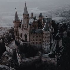 an aerial view of a castle in the fog