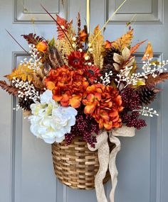 a basket filled with flowers sitting on top of a door