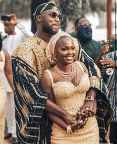 a man and woman dressed in traditional african clothing