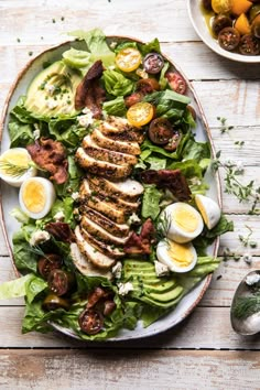 a salad with hard boiled eggs, bacon and lettuce