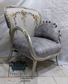 an old chair with floral designs on the back and arms is sitting in front of a white backdrop