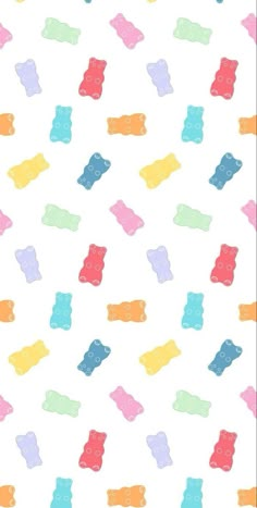 colorful gummy bears are scattered on a white background with blue, yellow, pink, and orange