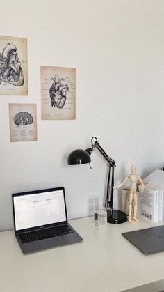 an open laptop computer sitting on top of a white desk