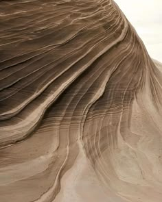 an image of the top of a sand dune with waves and lines on it's surface