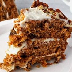 a piece of carrot cake with white frosting and pecans on the top slice