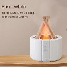 a white flame light with remote control sitting on a table next to a potted plant