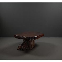 a wooden table sitting on top of a gray floor