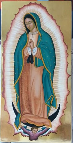 an icon of the virgin mary in gold and blue