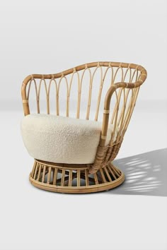 a wicker chair with a white cushion