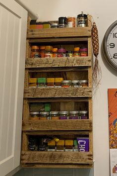 a wooden spice rack next to a clock on the wall