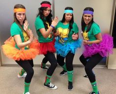 four girls dressed in costumes posing for the camera